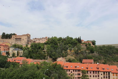 Houses in town against sky