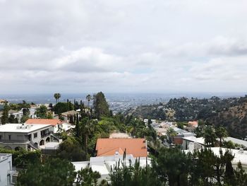 High angle view of houses in town against sky