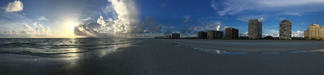 Panoramic view of sea and buildings against sky