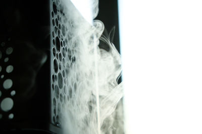 Close-up of smoke emitting from glass