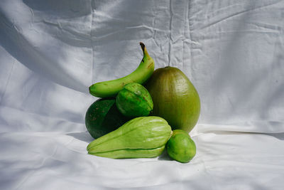 High angle view of green fruits on bed