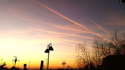 Low angle view of silhouette trees against sky at sunset
