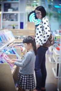 Mother and daughter standing on floor