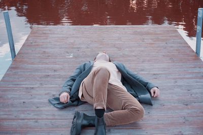 Rear view of man walking on pier