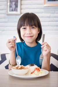 Portrait of smiling boy eating food