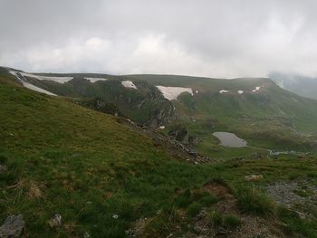 Scenic view of landscape against cloudy sky