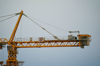 Low angle view of crane against clear sky