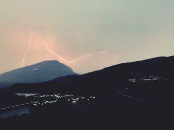 Scenic view of illuminated mountains against sky at night