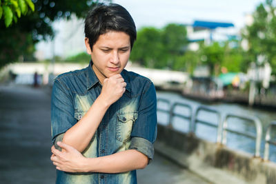 Portrait of a teenage boy standing in city