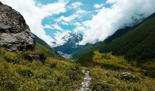 Scenic view of mountains against cloudy sky