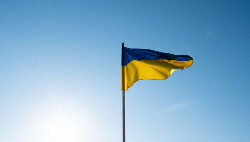 Flag of ukraine on blue sky background.