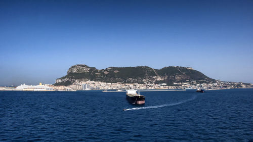 Boats moored in water off gibraltar 