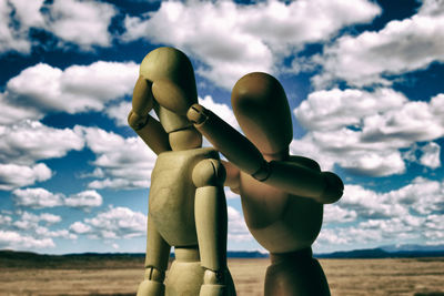 Stuffed toy on beach against sky