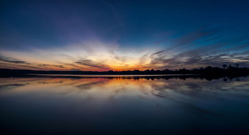 Scenic view of lake against romantic sky at sunset