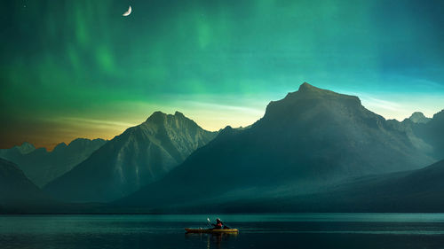 Scenic view of sea and mountains against sky during sunset