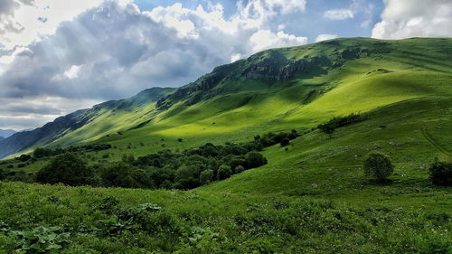 Scenic view of mountains against cloudy sky