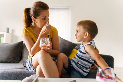 Mother and daughter sitting on floor