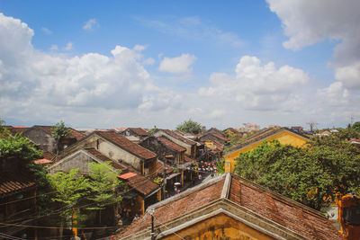 Buildings in city against cloudy sky