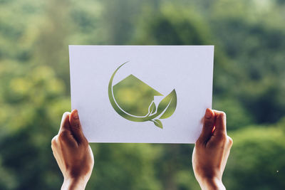 Midsection of woman holding paper