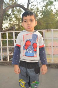 Portrait of cute boy standing outdoors