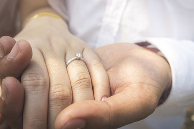 Close-up of couple holding hands