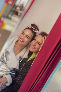 Smiling lesbian couple sitting at home