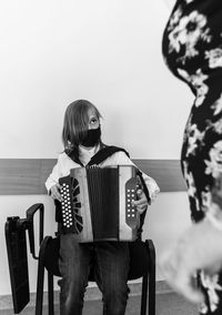 Portrait of a boy in accordion lesson