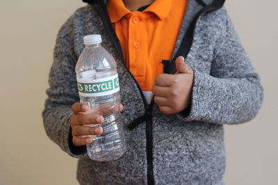 Close-up of woman hand holding bottle