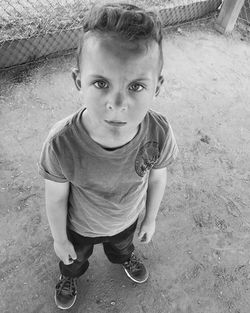 Full length portrait of boy standing on field