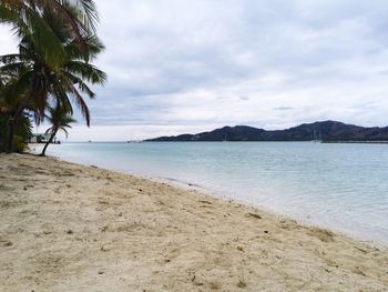 Scenic view of sea against cloudy sky