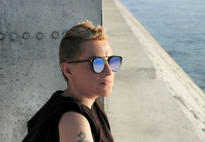 Portrait of man wearing sunglasses against sea