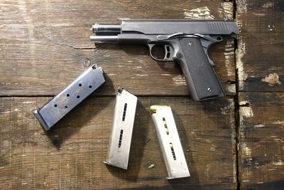 High angle view of handguns on wooden table