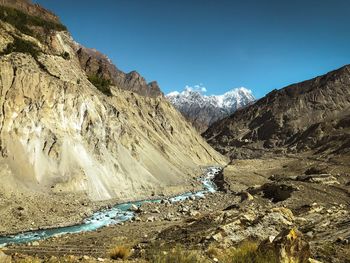 Scenic view of snowcapped mountains against blue sky