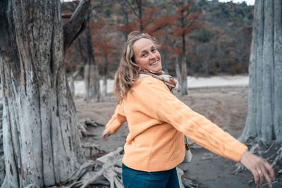 Portrait of a smiling young woman in forest