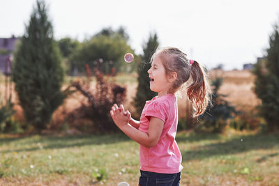 Side view of girl standing on field