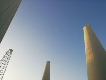 Low angle view of smoke stack against sky