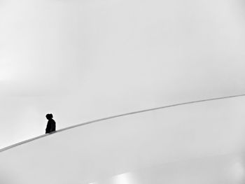 Silhouette of cables against clear sky