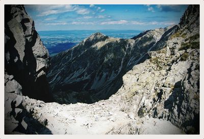 Scenic view of sea and mountains against sky