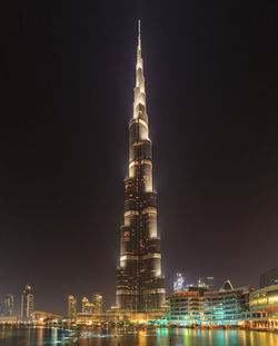 Low angle view of illuminated city lit up at night