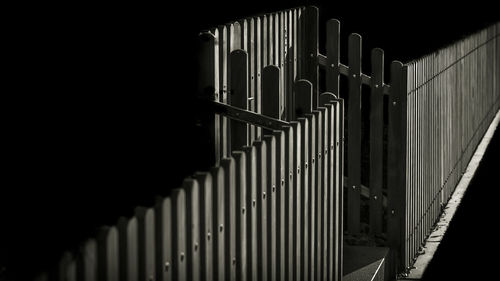 Close-up of wooden fence at night