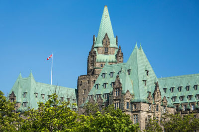 Low angle view of buildings against blue sky