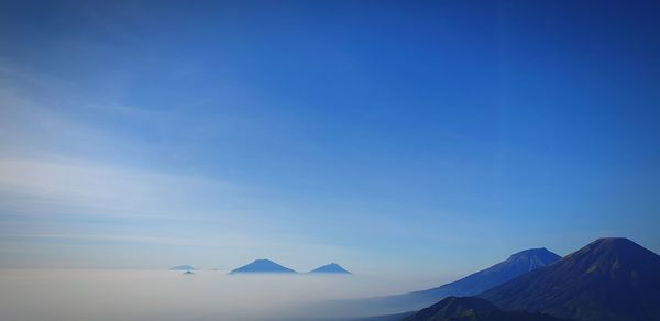 View of volcanic mountain against blue sky