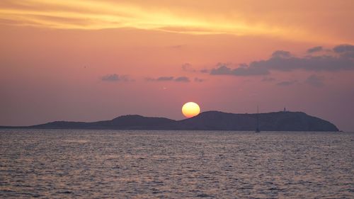 Scenic view of sea against romantic sky at sunset