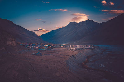 Scenic view of sea and mountains against sky during sunset