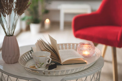 Coffee cup and book on table