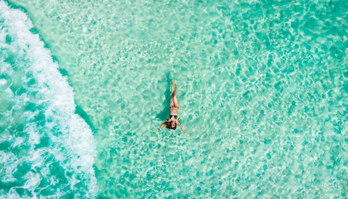 High angle view of woman swimming in sea