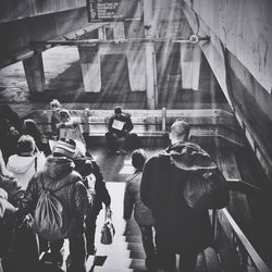 People on staircase leading towards subway station