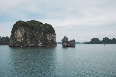 Scenic view of rocks in sea against sky