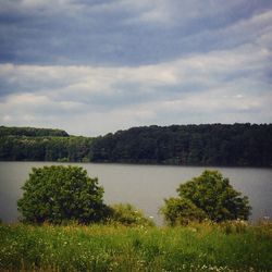 Scenic view of lake against cloudy sky