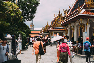 Group of people outside temple against building